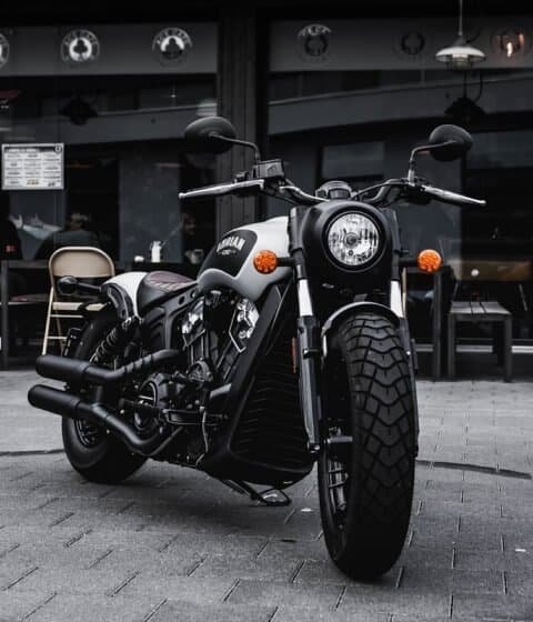 The Indian Scout is parked in front of a restaurant, far away from the comfort of home.