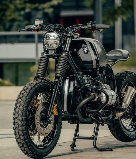 A black motorcycle parked in front of a home.