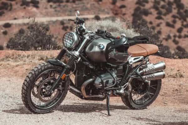 A motorcycle is parked on a dirt road.